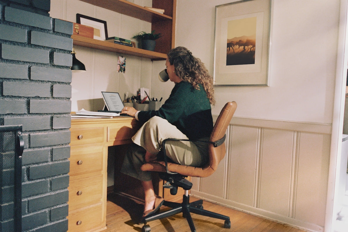 Woman working at desk with coffee