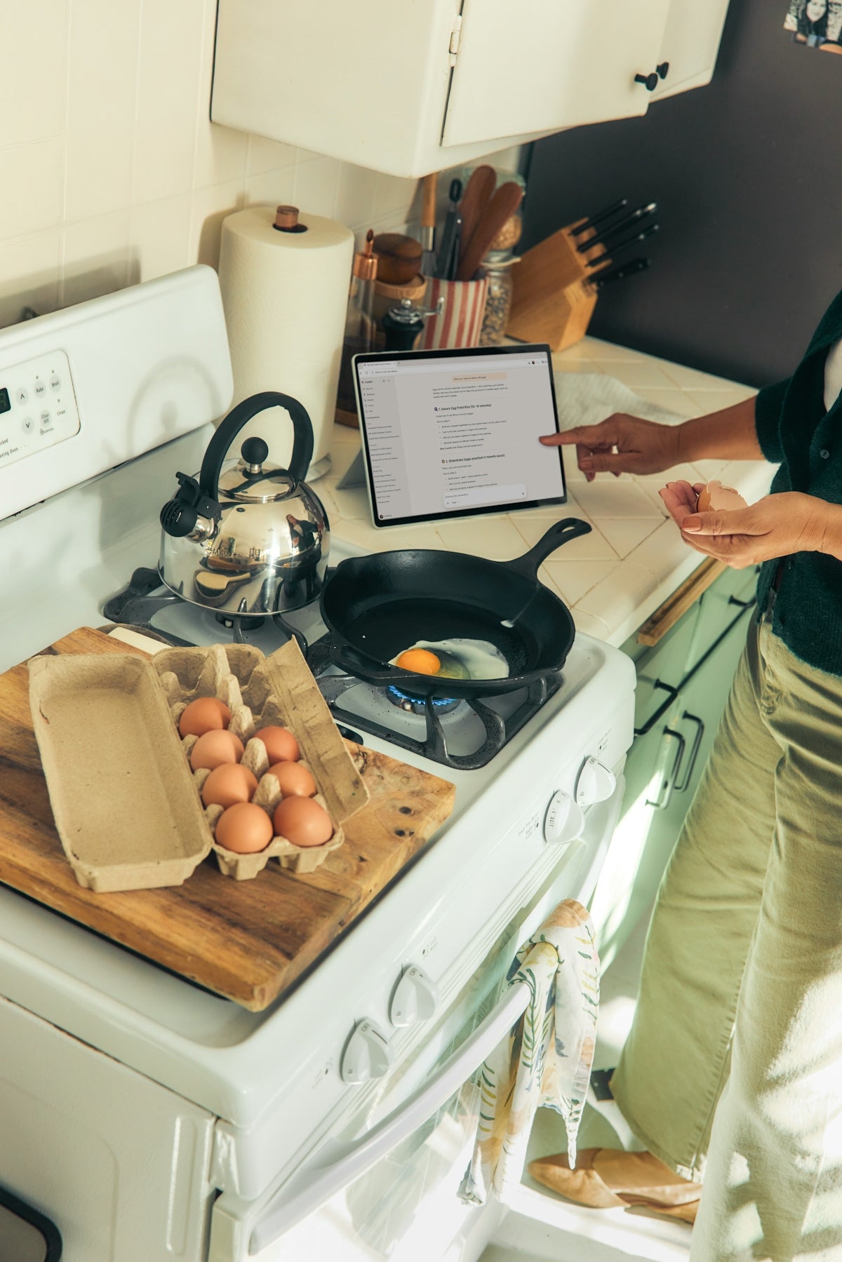 Person cooking eggs on a stovetop following a recipe.